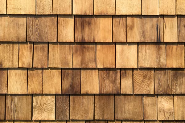 A background of newly roof  installed wooden cedar shingles.