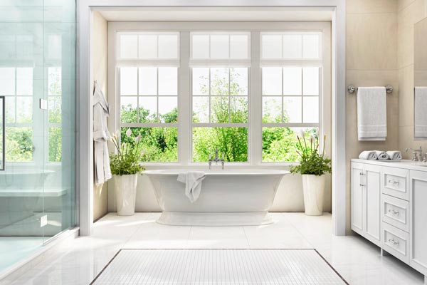 White bathroom with bath and large window